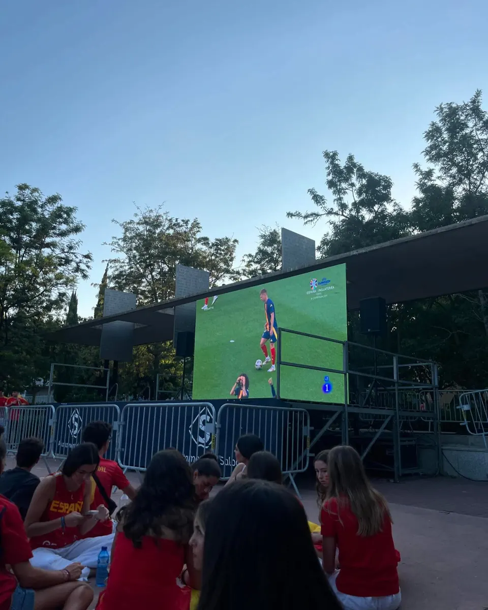 Crowd watching a Euro match on an outdoor LED screen